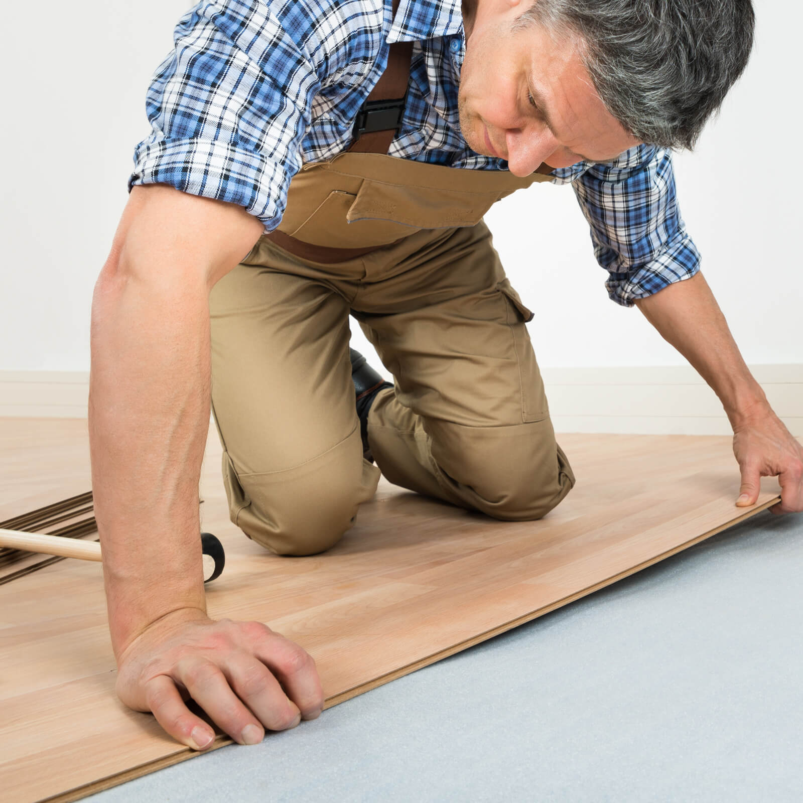 Worker installing tile | The Floor Store
