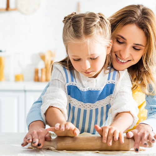 mom and daughter rolling out dough on a durable countertop in a kitchen | The Floor Store