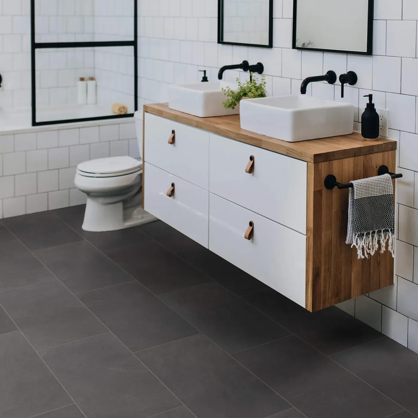 Callisto-12x24-430TS-Ember-00900-RM-V Shaw Floors Ember dark gray rectangular tile in a modern bathroom | The Floor Store