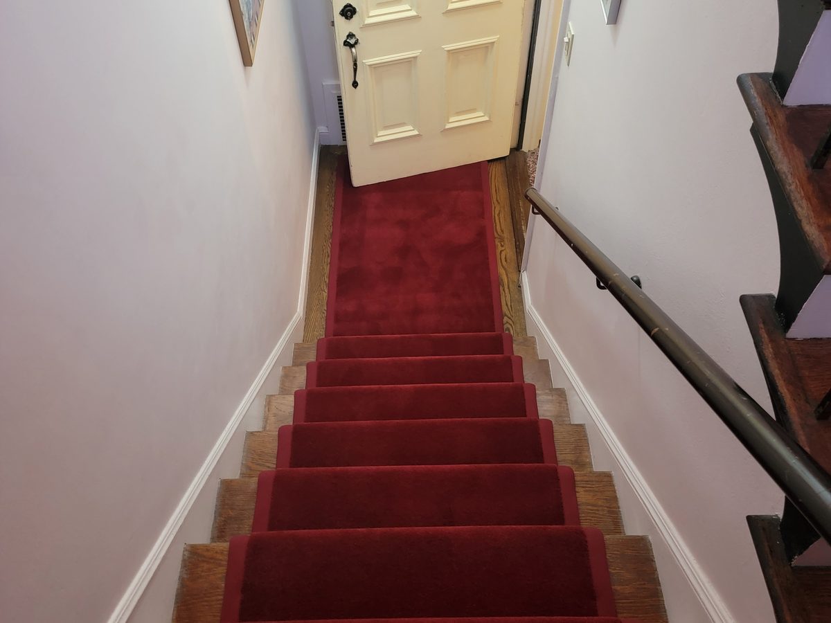 Red stair runner with wide fabric binding