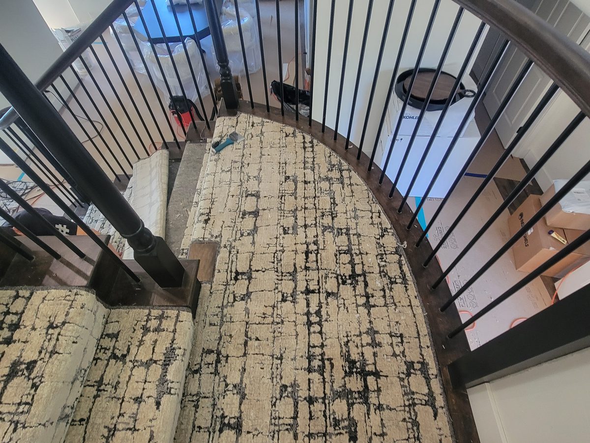 Curved staircase with textured carpet runner