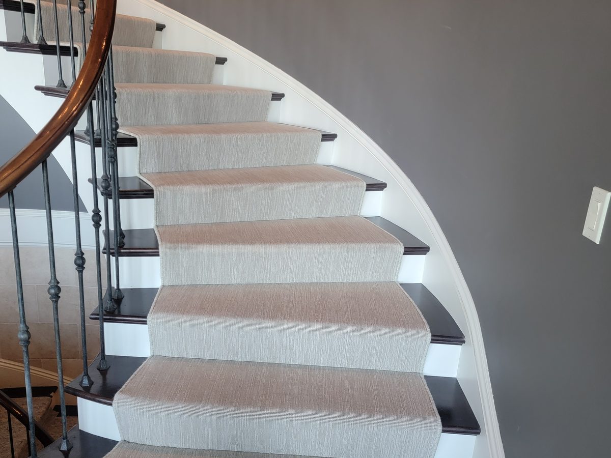 Spiral staircase with a custom carpet runner