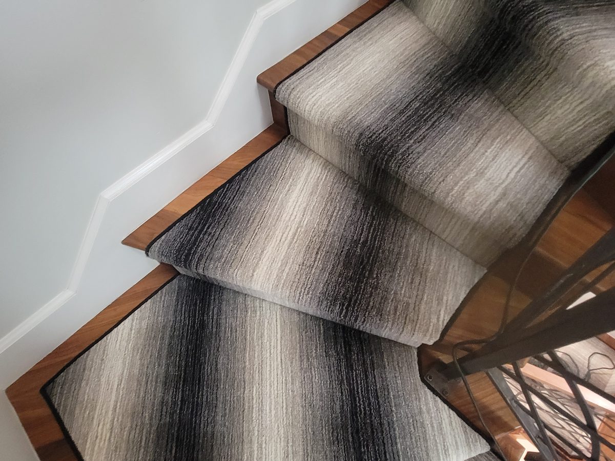 Ombré striped runner on winding stairs